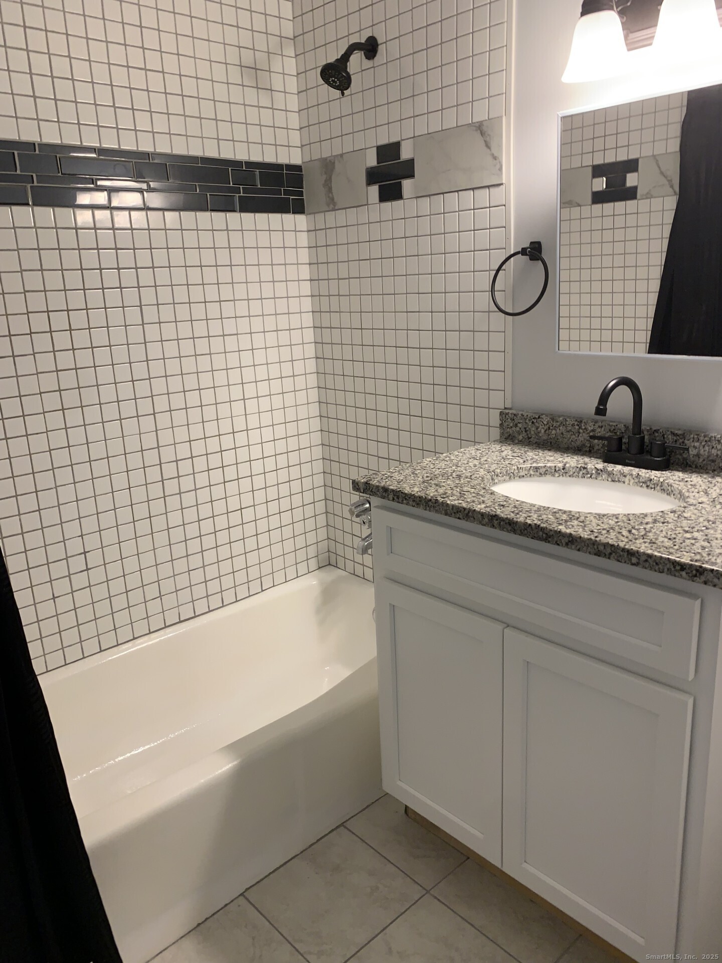 507 Emmett Street, Unit 13 Bristol, CT 06010 - Photo 16 of 16 a bathroom with a granite countertop sink a toilet and mirror