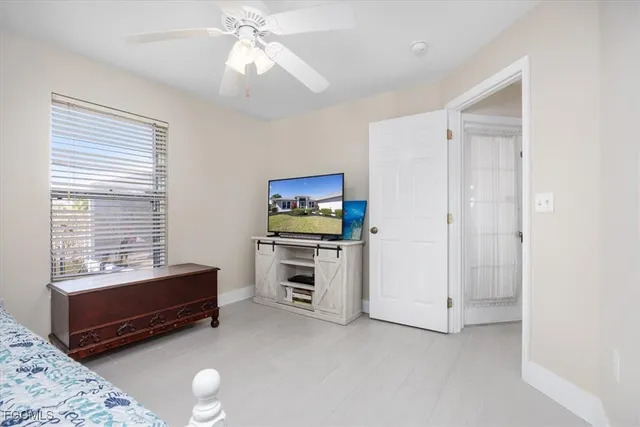 a bedroom with furniture and a window