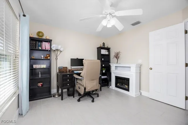 a view of a workspace with furniture and a fireplace