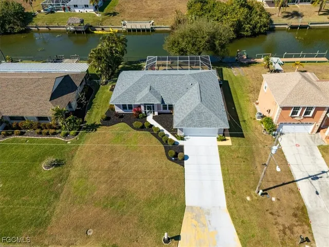 an aerial view of a house with a lake view
