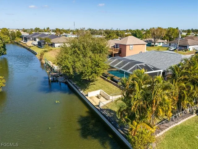 a view of residential houses with outdoor space and lake view