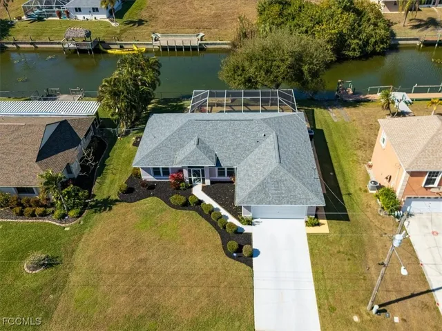 an aerial view of a house with a lake view