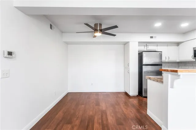 a view of a kitchen with a sink and a refrigerator