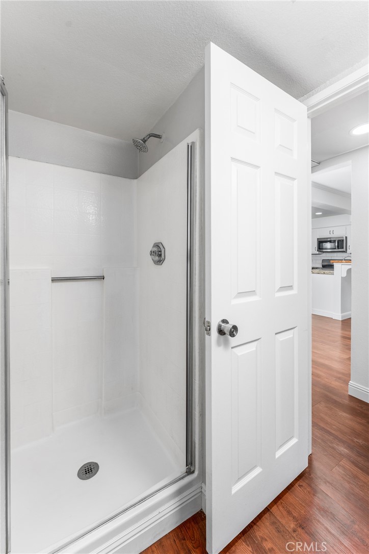 34264 Camino Capistrano, Unit 102 Dana Point, CA 92624 - Photo 18 of 37 a bathroom with a glass shower door