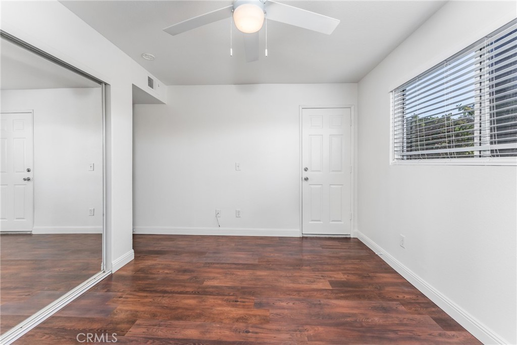 34264 Camino Capistrano, Unit 102 Dana Point, CA 92624 - Photo 19 of 37 an empty room with wooden floor and windows