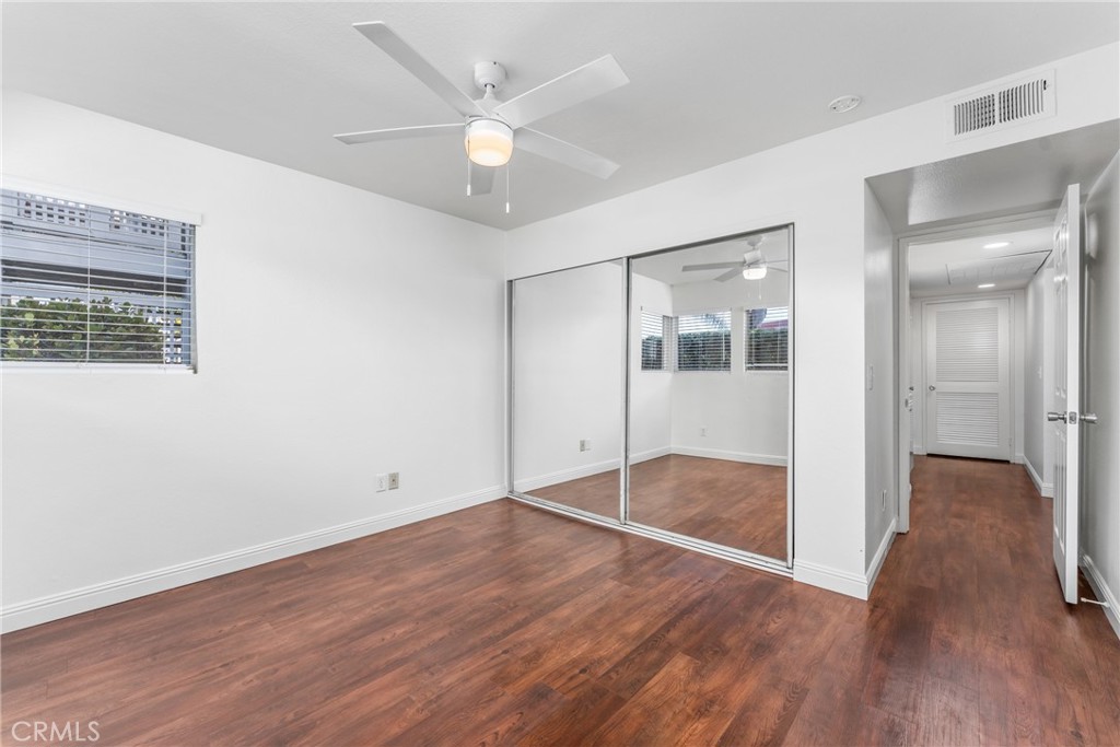 34264 Camino Capistrano, Unit 102 Dana Point, CA 92624 - Photo 21 of 37 an empty room with wooden floor and mirror