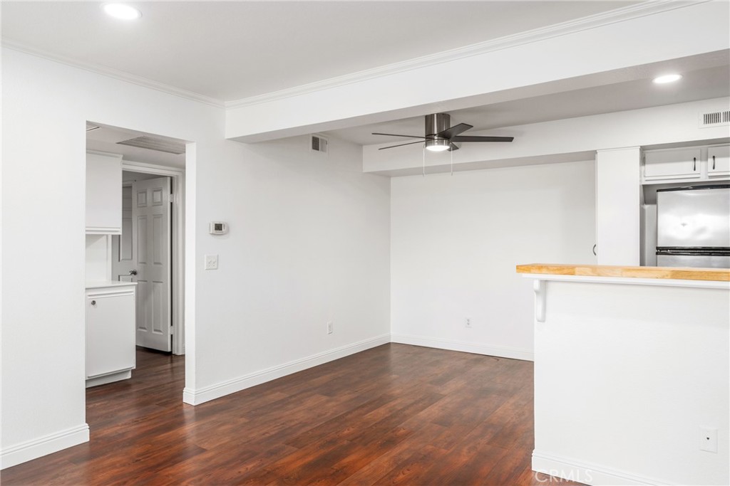 34264 Camino Capistrano, Unit 102 Dana Point, CA 92624 - Photo 3 of 37 a view of a kitchen with a sink and wooden floor