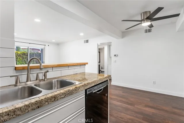 a kitchen with a sink and a refrigerator