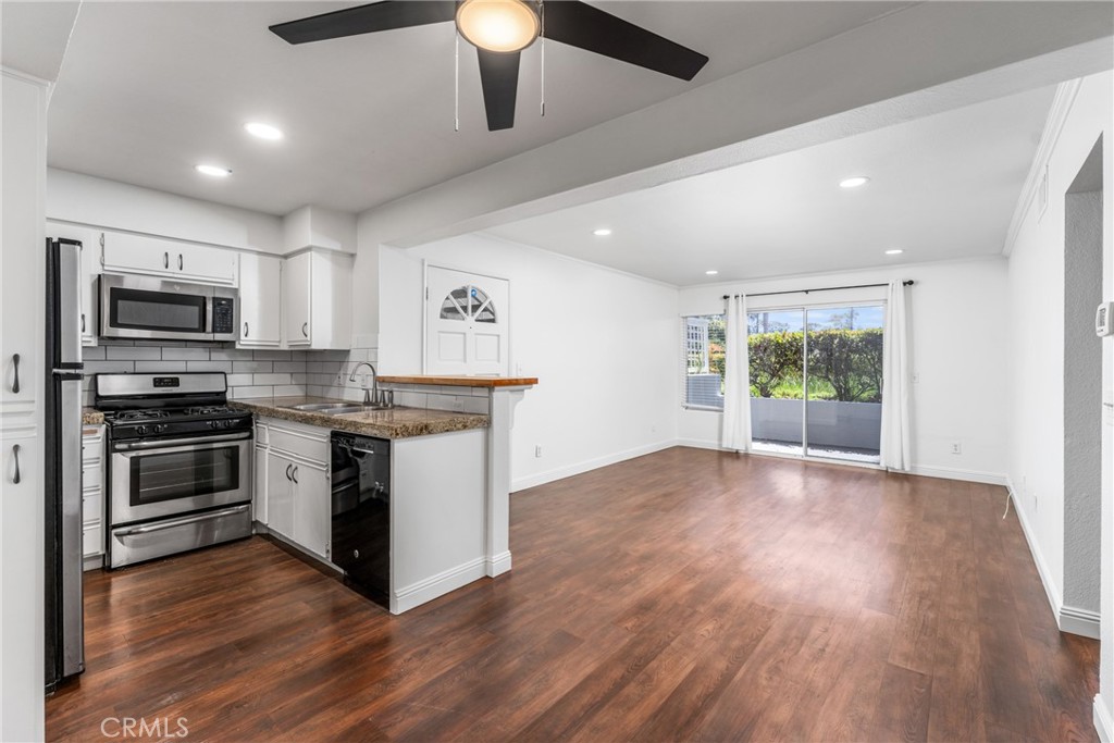 34264 Camino Capistrano, Unit 102 Dana Point, CA 92624 - Photo 9 of 37 a kitchen with a stove a sink and a microwave