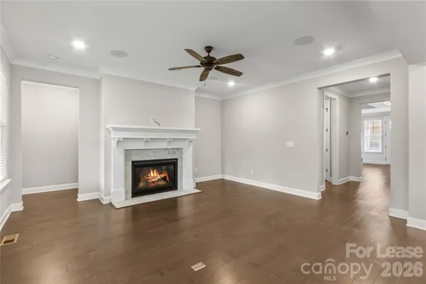 a view of an empty room with a fireplace and a window