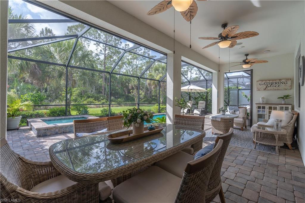 6848 Winding Cypress Drive Naples, FL 34114 - Photo 14 of 47 a living room with furniture and a large window