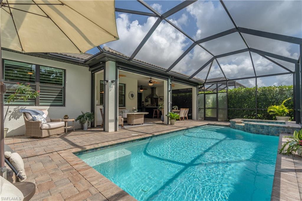 6848 Winding Cypress Drive Naples, FL 34114 - Photo 19 of 47 a view of a house with backyard sitting area and porch