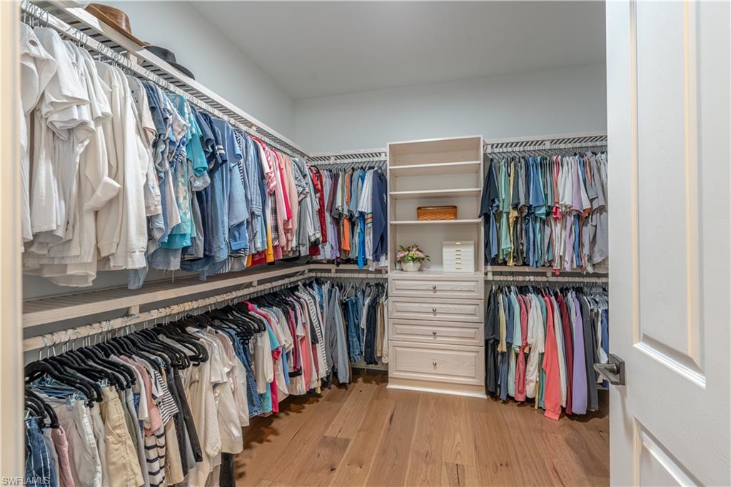 6848 Winding Cypress Drive Naples, FL 34114 - Photo 24 of 47 a view of walk in closet with clothes and shoes
