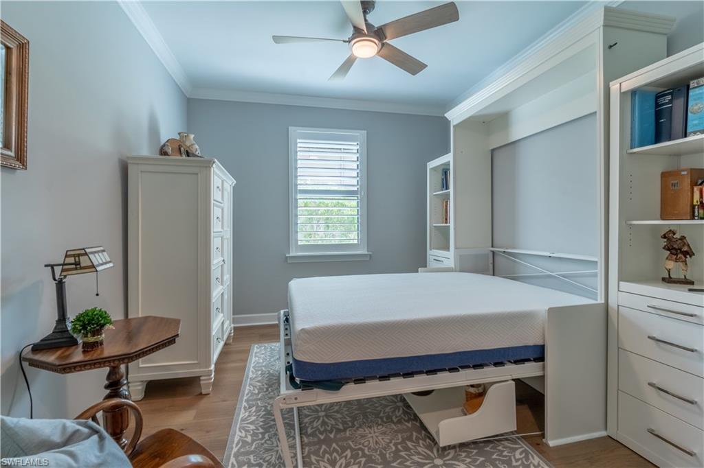 6848 Winding Cypress Drive Naples, FL 34114 - Photo 26 of 47 a room with a bed and furniture