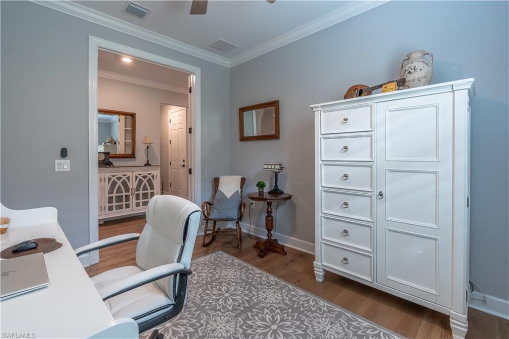 6848 Winding Cypress Drive Naples, FL 34114 - Photo 27 of 47 a view of a workspace with furniture and a dresser