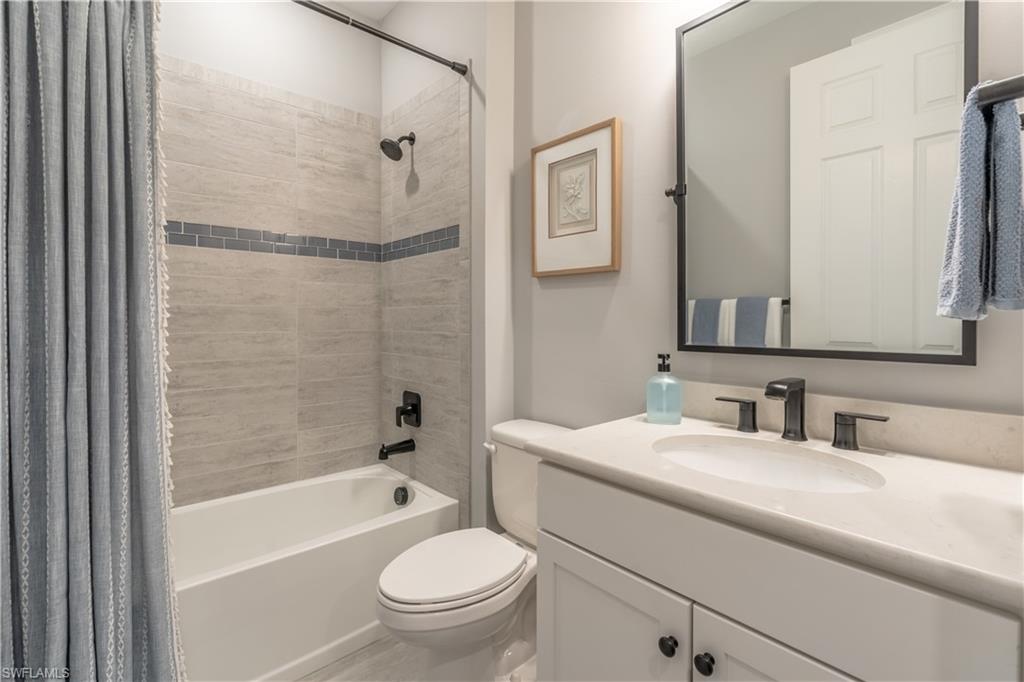 6848 Winding Cypress Drive Naples, FL 34114 - Photo 28 of 47 a bathroom with a toilet a sink and a bathtub