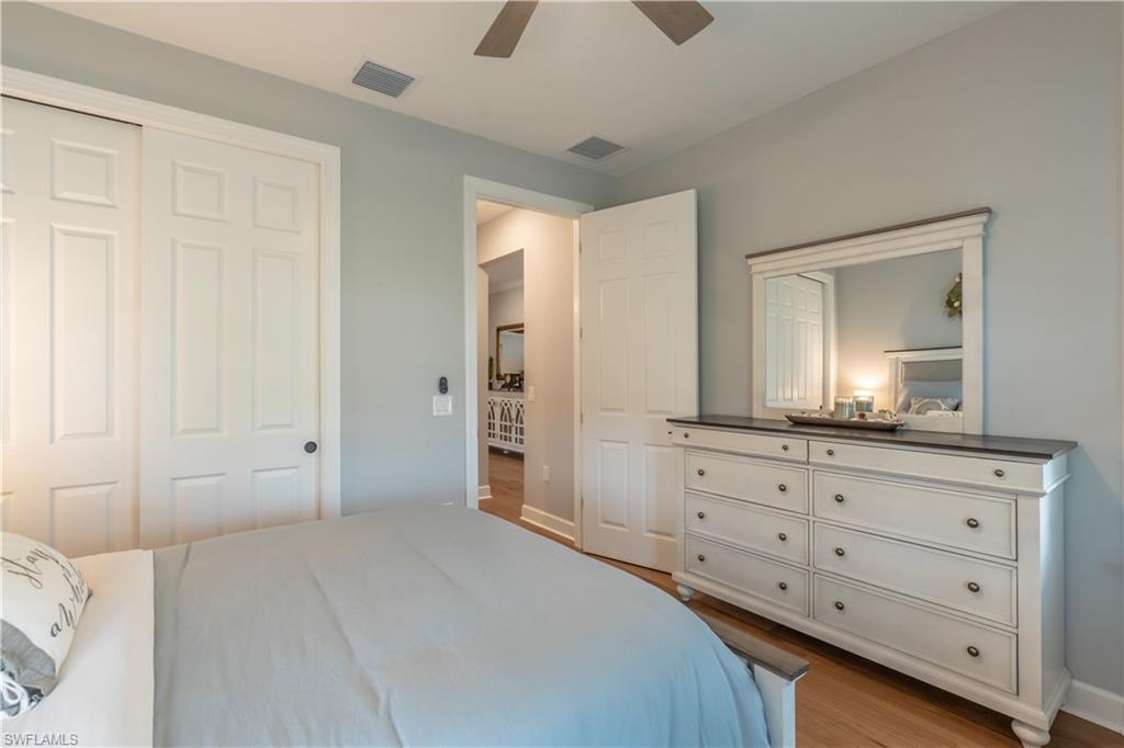 6848 Winding Cypress Drive Naples, FL 34114 - Photo 30 of 47 a bedroom with a bed and a dresser