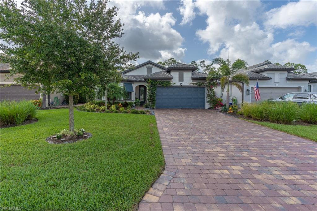 6848 Winding Cypress Drive Naples, FL 34114 - Photo 33 of 47 a front view of a house with garden