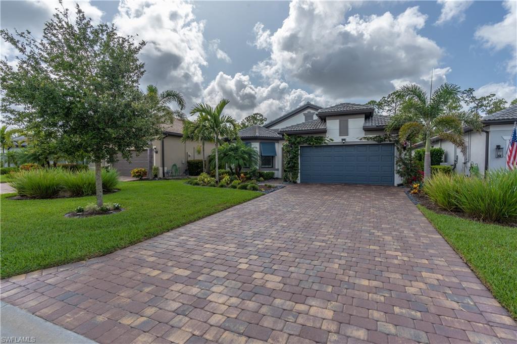 6848 Winding Cypress Drive Naples, FL 34114 - Photo 34 of 47 a front view of a house with garden