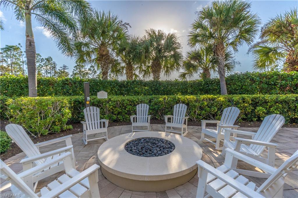 6848 Winding Cypress Drive Naples, FL 34114 - Photo 44 of 47 a view of a patio with couches chairs potted plants and a palm tree