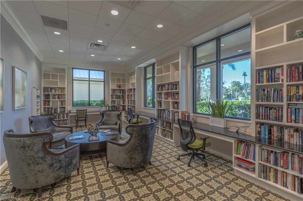 6848 Winding Cypress Drive Naples, FL 34114 - Photo 46 of 47 a living room with furniture lots of books and a large window