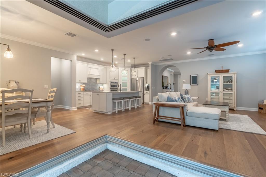 6848 Winding Cypress Drive Naples, FL 34114 - Photo 5 of 47 a living room with furniture and kitchen view