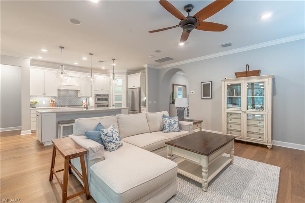 6848 Winding Cypress Drive Naples, FL 34114 - Photo 8 of 47 a living room with furniture and a view of kitchen