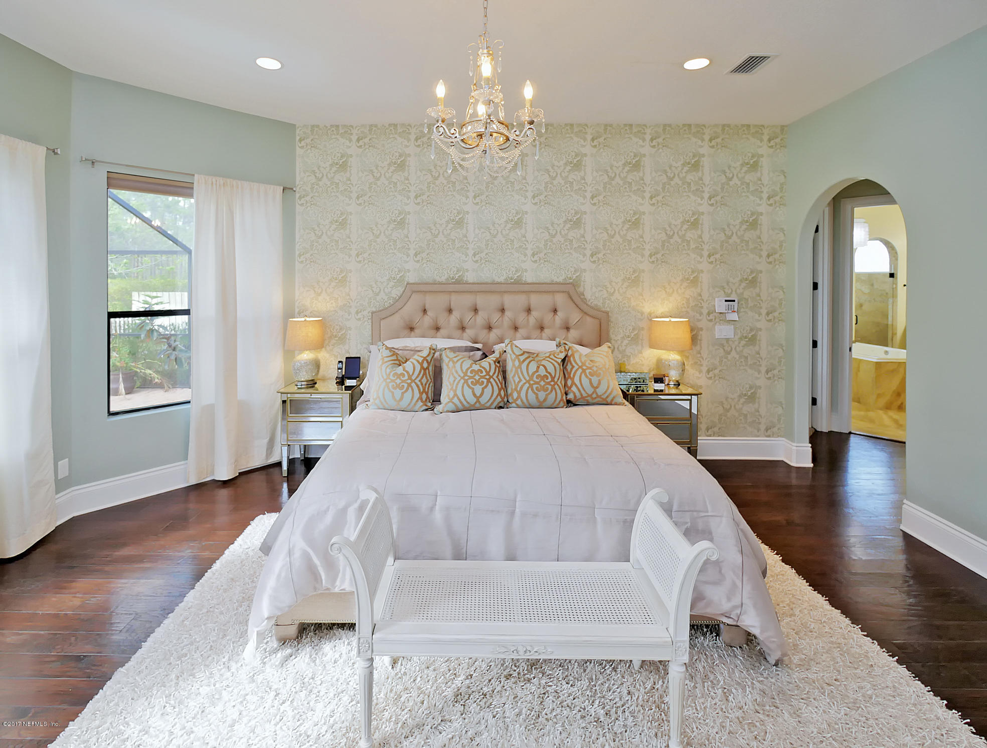 8074 Green Glade Road Jacksonville, FL 32256 - Photo 30 of 71 a spacious bedroom with a bed and wooden floor