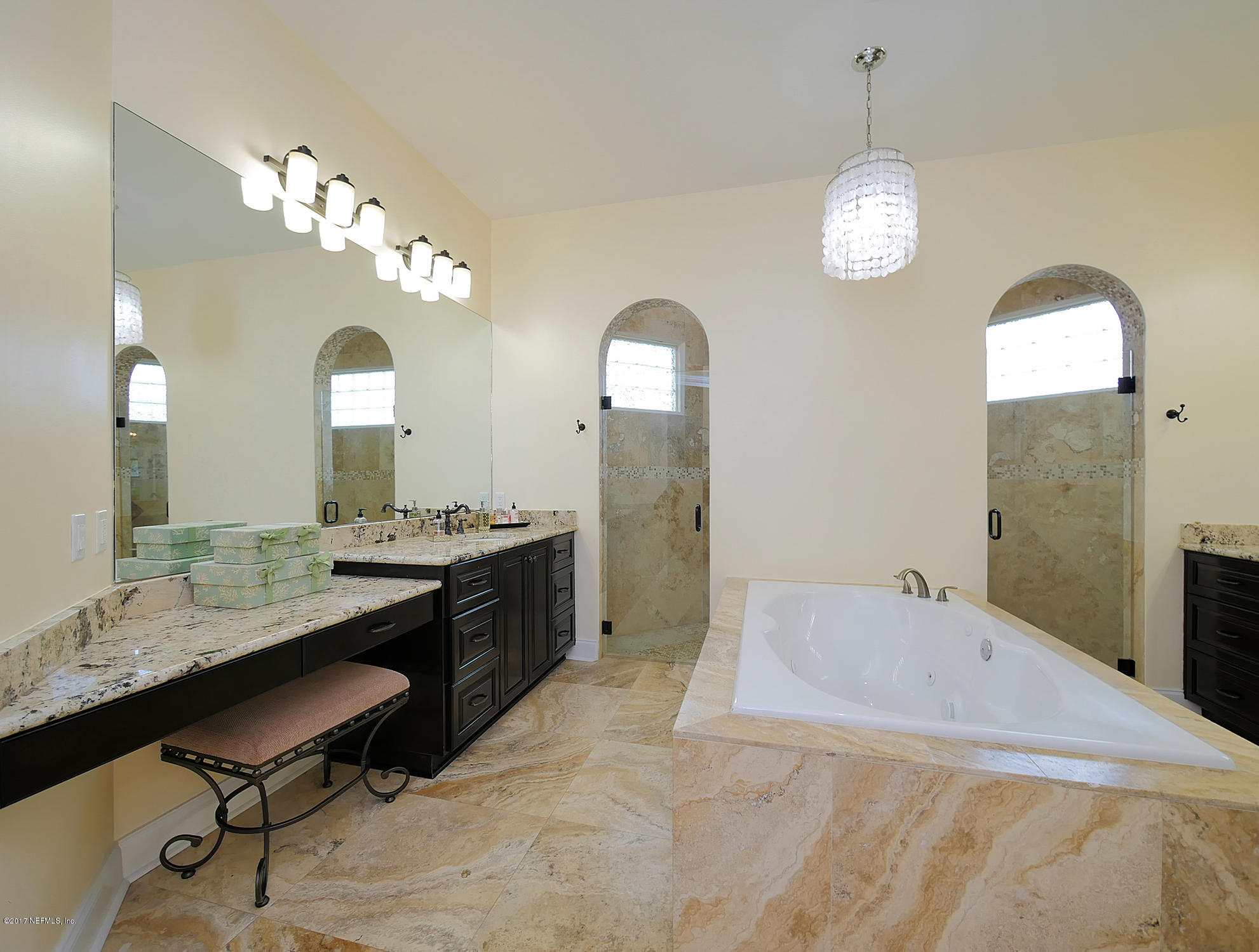 8074 Green Glade Road Jacksonville, FL 32256 - Photo 33 of 71 a spacious bathroom with a granite countertop sink a mirror and a shower