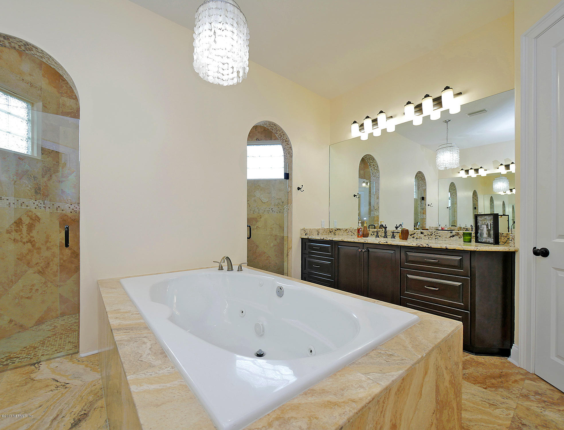8074 Green Glade Road Jacksonville, FL 32256 - Photo 34 of 71 a spacious bathroom with a granite countertop sink a mirror and a bathtub