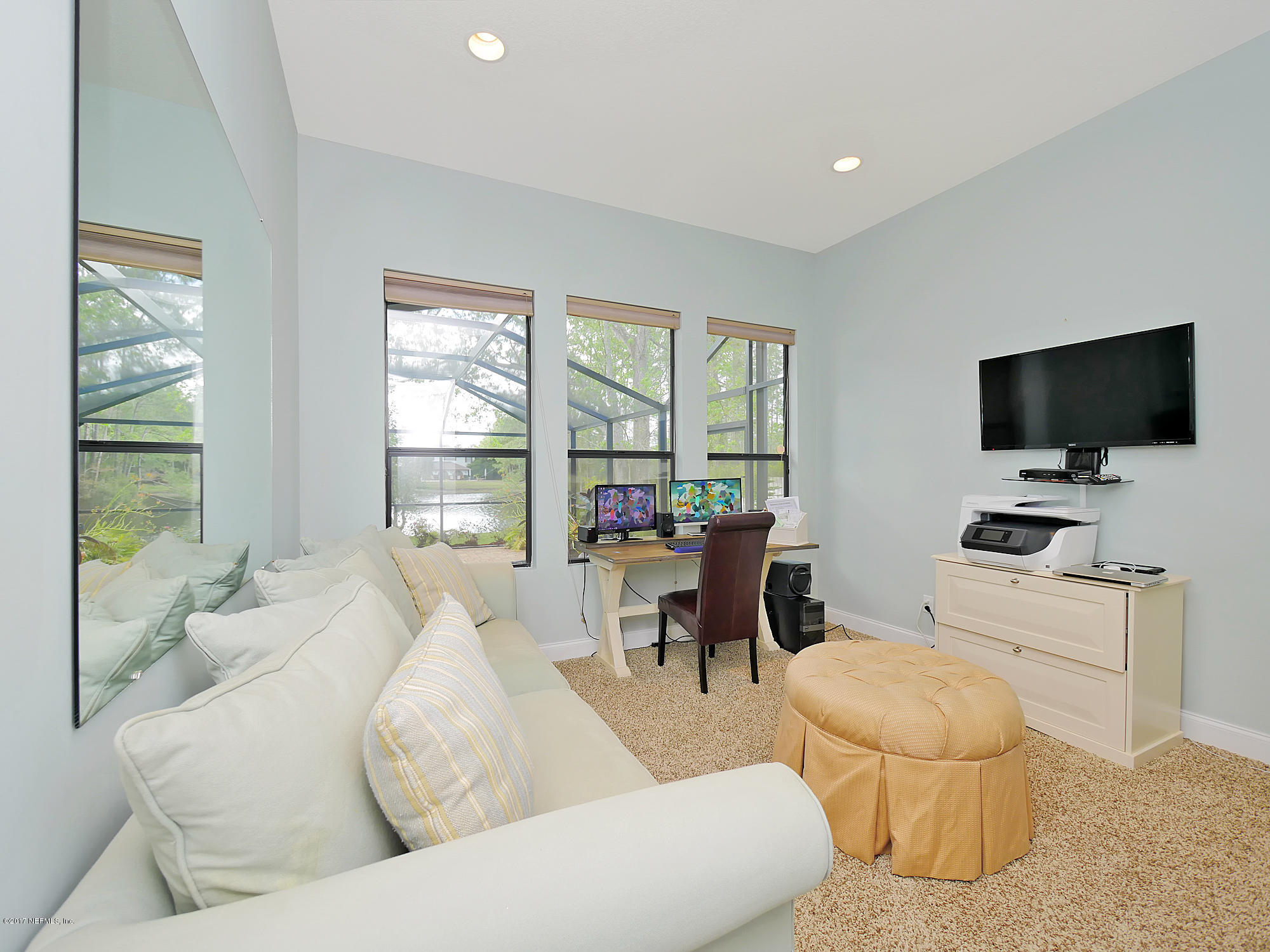8074 Green Glade Road Jacksonville, FL 32256 - Photo 35 of 71 a living room with furniture and a flat screen tv