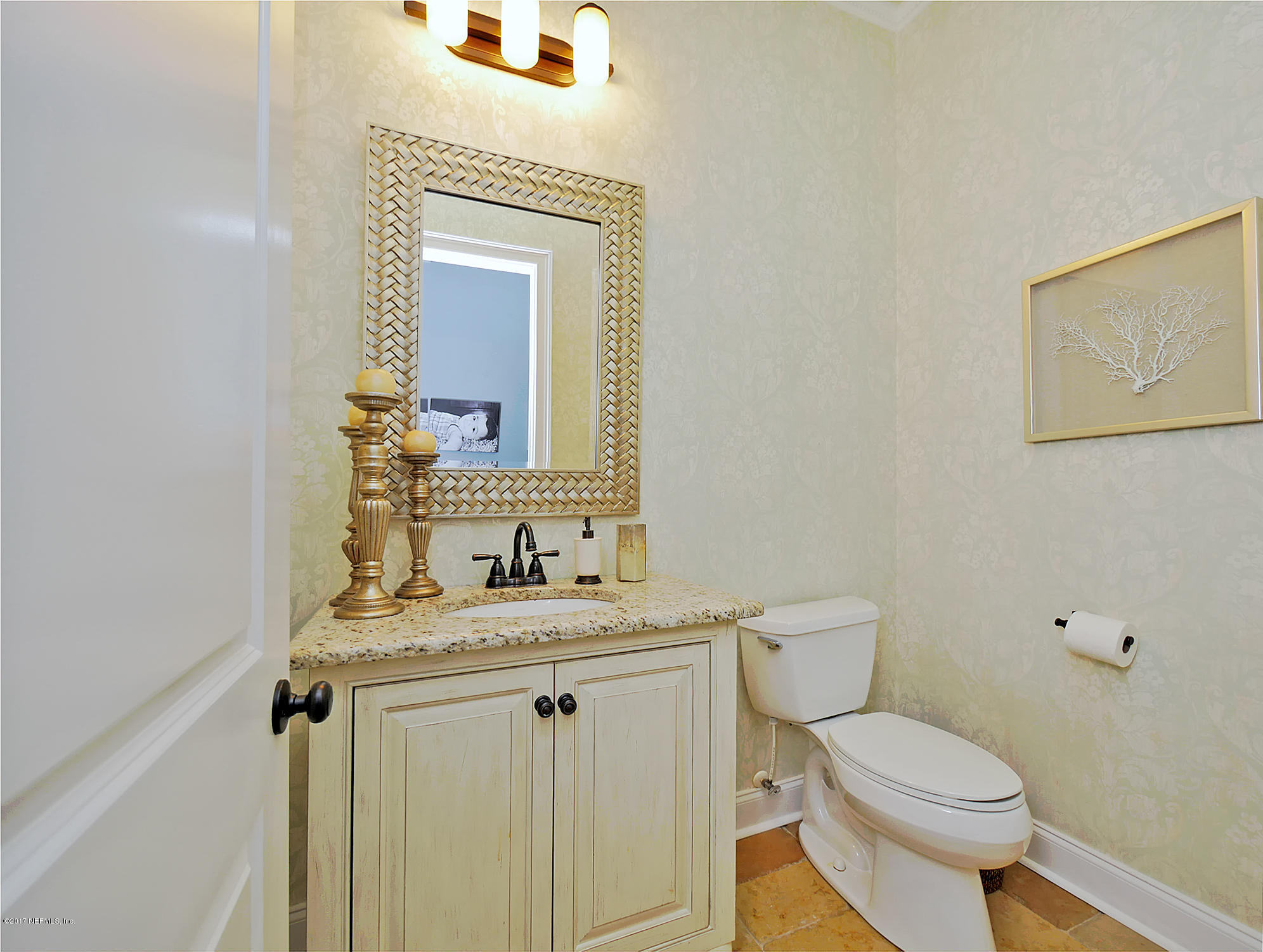 8074 Green Glade Road Jacksonville, FL 32256 - Photo 38 of 71 a bathroom with a toilet a sink and mirror