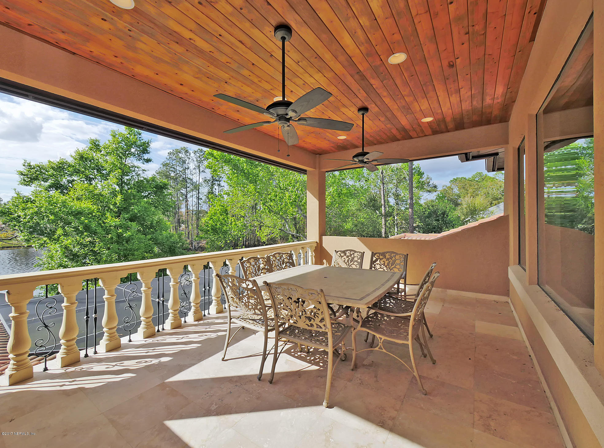 8074 Green Glade Road Jacksonville, FL 32256 - Photo 44 of 71 a view of a patio with table and chairs under an umbrella with a small yard