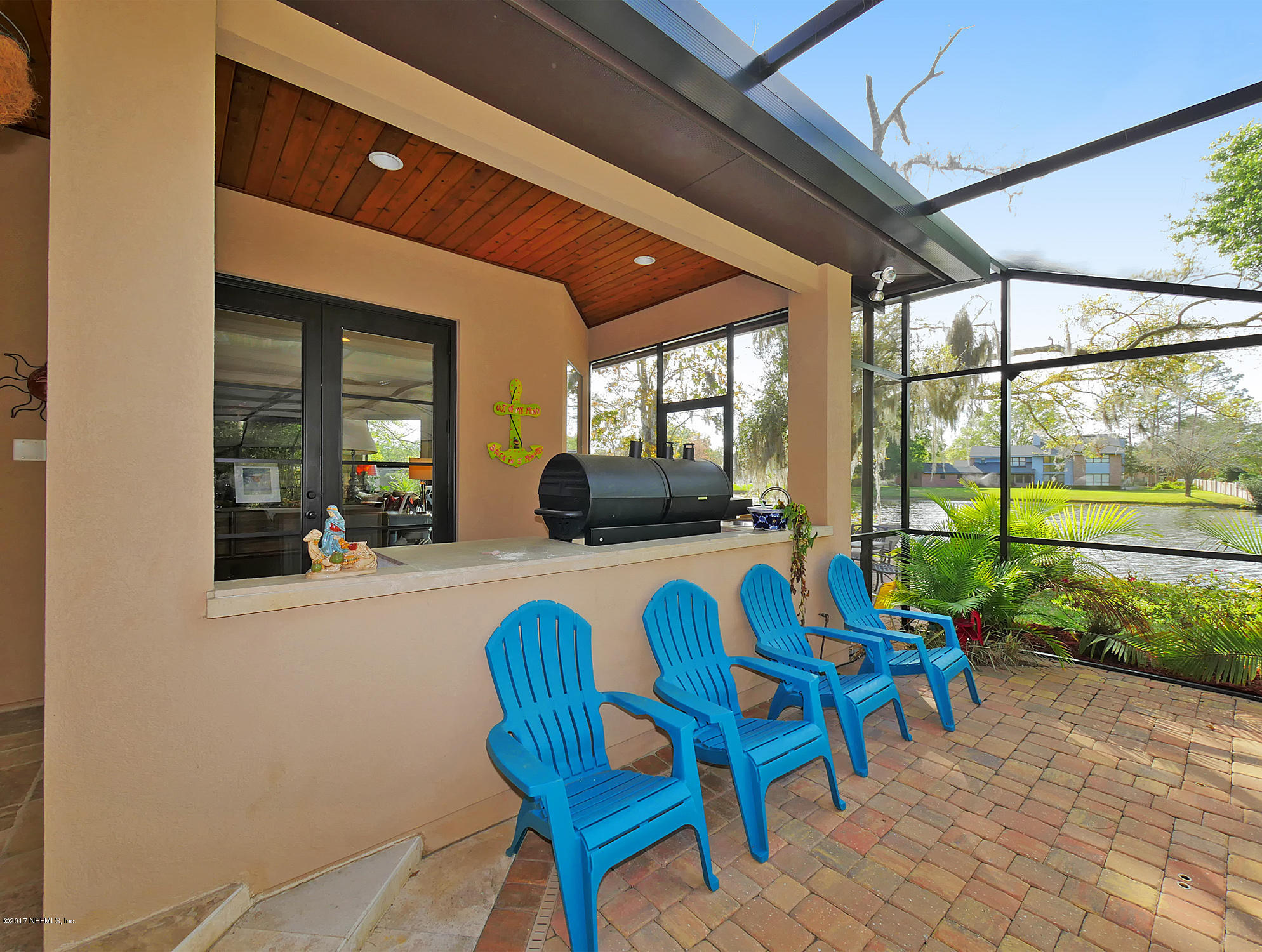 8074 Green Glade Road Jacksonville, FL 32256 - Photo 57 of 71 a dining room with furniture and a floor to ceiling window