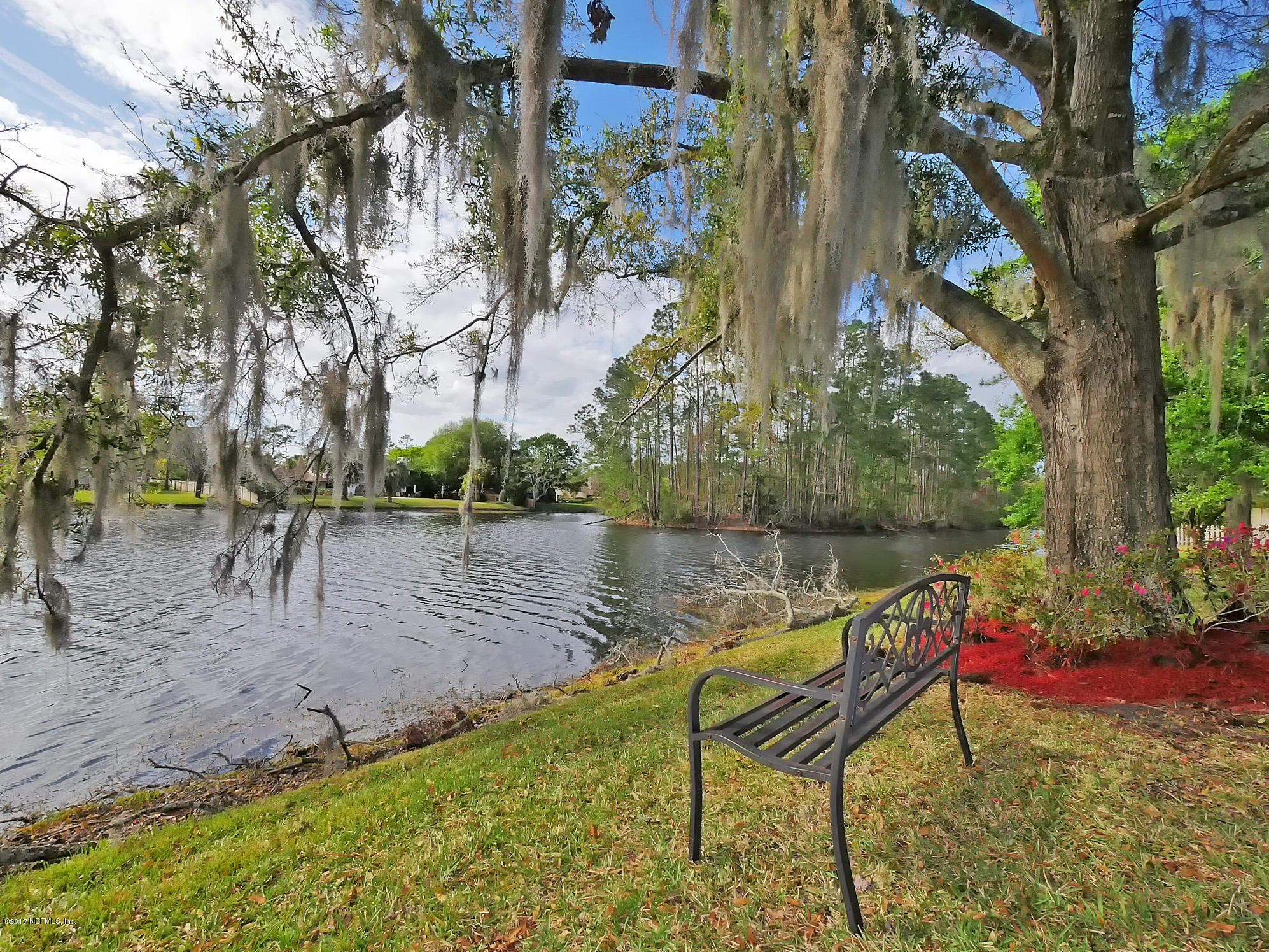 8074 Green Glade Road Jacksonville, FL 32256 - Photo 66 of 71 a view of a lake with a bench