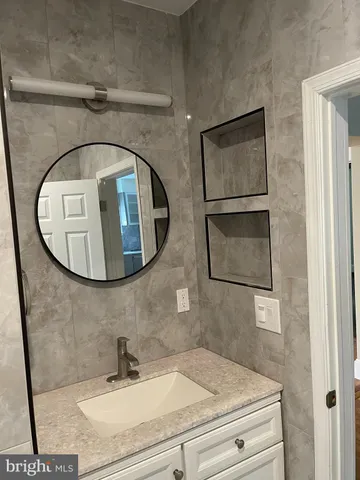 a bathroom with a sink and mirror