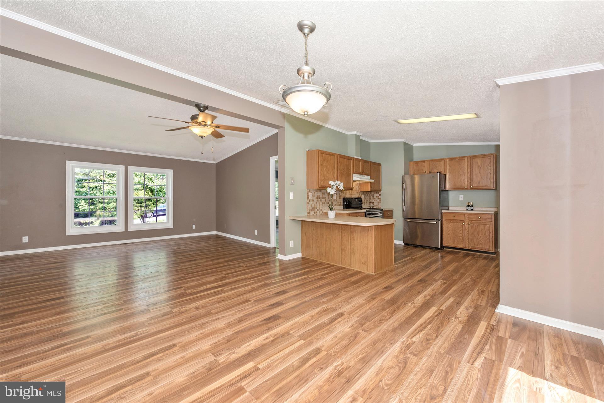 10551 Rum Springs Road Frederick, MD 21702 - Photo 6 of 24 a view of a kitchen with wooden floor and a window