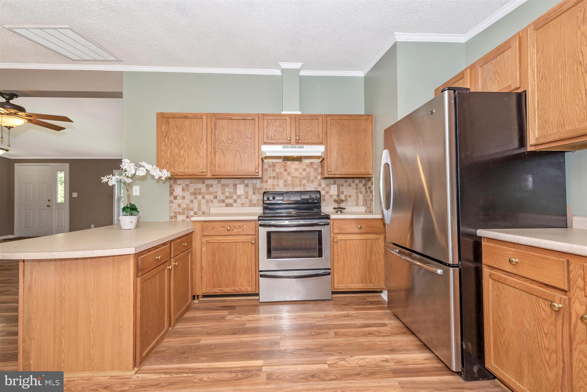 10551 Rum Springs Road Frederick, MD 21702 - Photo 8 of 24 a kitchen with granite countertop a refrigerator stove and sink
