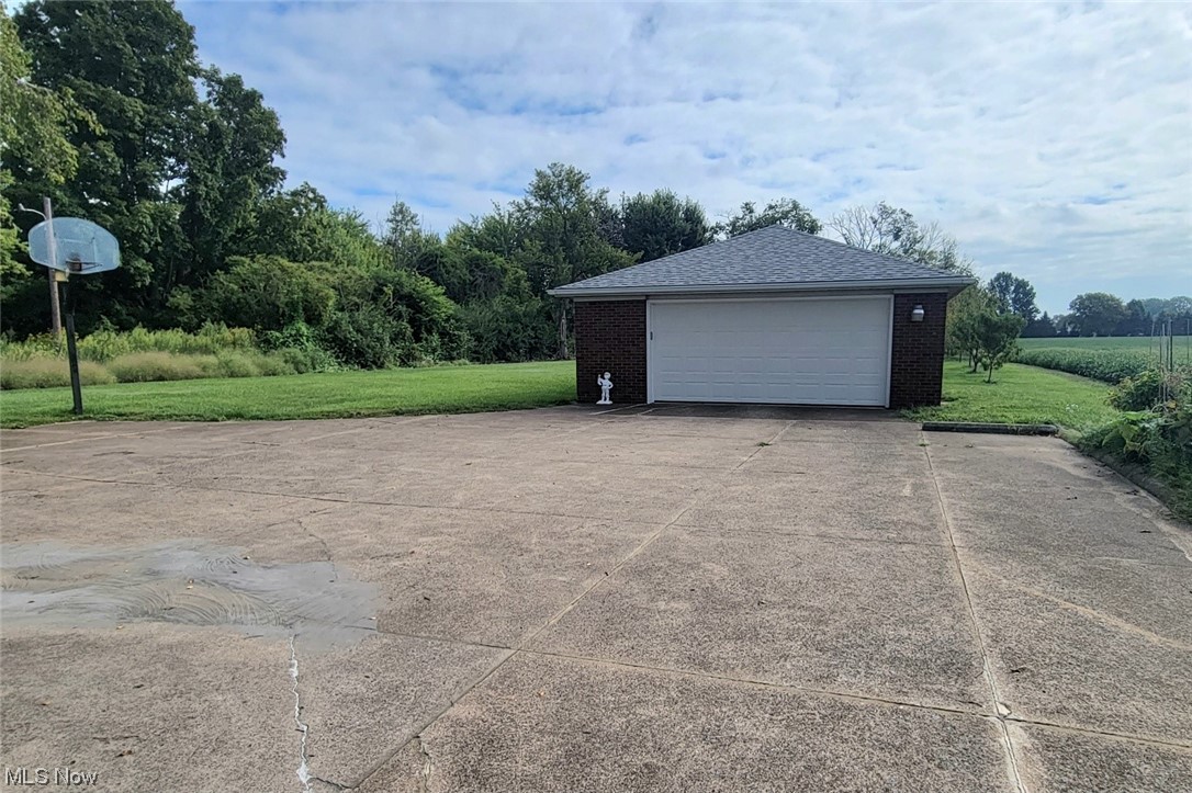 6416 Milan Road Sandusky, OH 44870 - Photo 4 of 34 Garage with garage and a yard