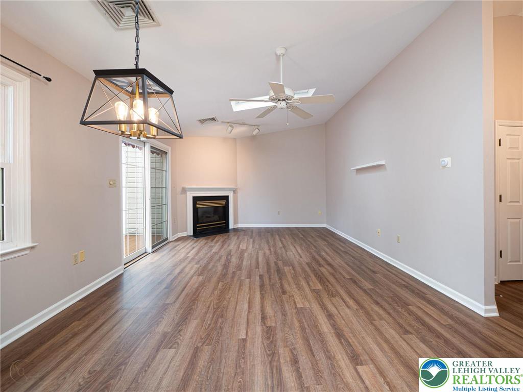 3217 Garfield Avenue, Unit E Reading, PA 19605 - Photo 11 of 45 a view of a room with wooden floor ceiling fan and window