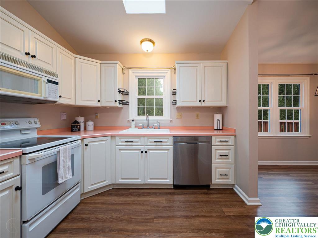 3217 Garfield Avenue, Unit E Reading, PA 19605 - Photo 19 of 45 a kitchen with granite countertop white cabinets and white appliances