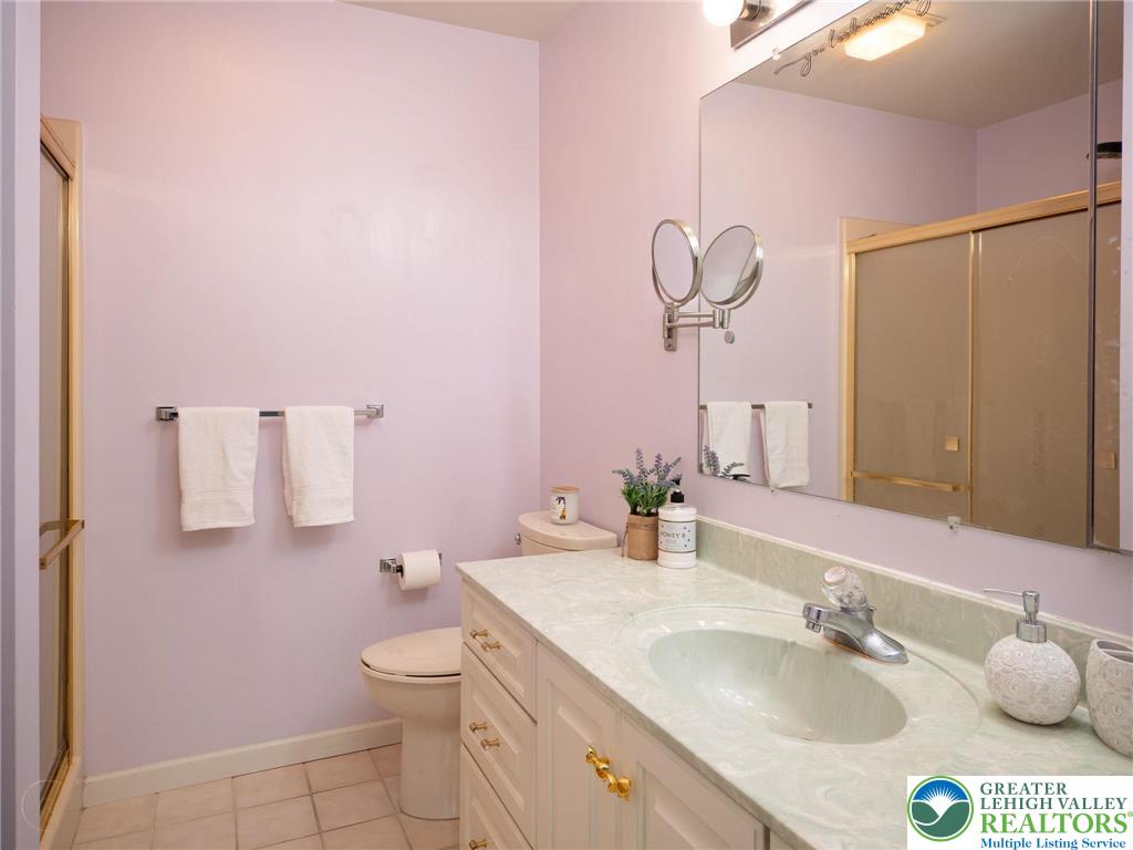 3217 Garfield Avenue, Unit E Reading, PA 19605 - Photo 25 of 45 a bathroom with a granite countertop sink a toilet and a mirror