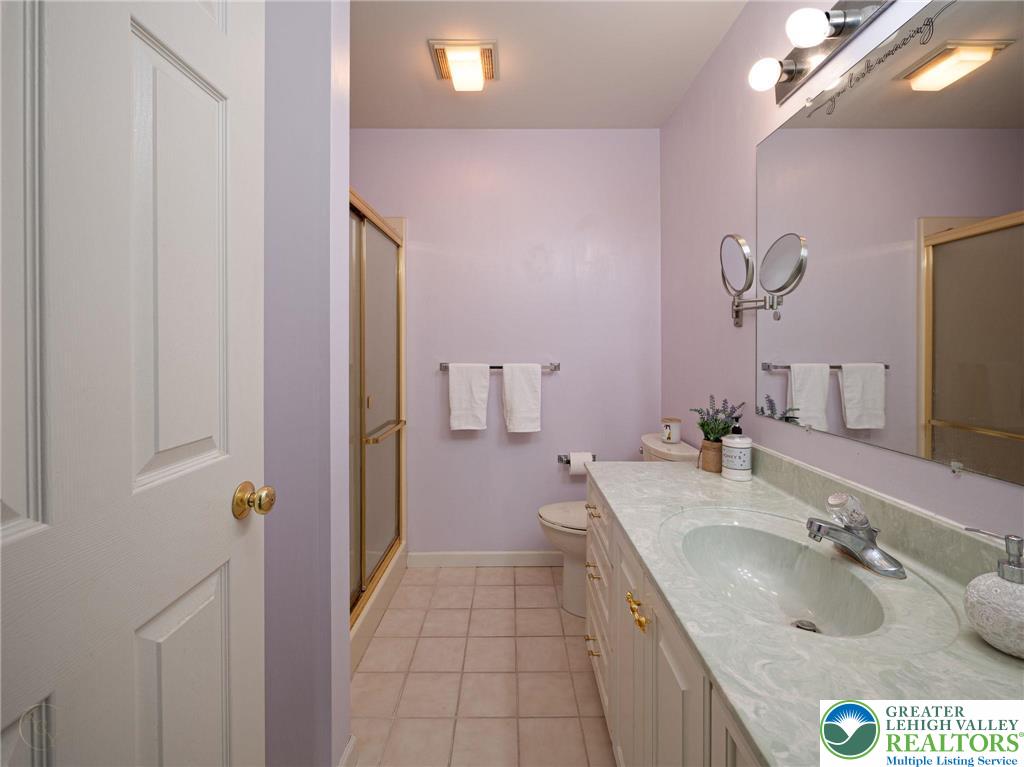 3217 Garfield Avenue, Unit E Reading, PA 19605 - Photo 26 of 45 a bathroom with a granite countertop sink a mirror and shower