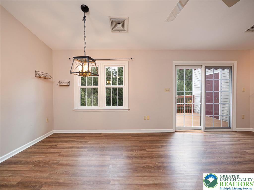 3217 Garfield Avenue, Unit E Reading, PA 19605 - Photo 7 of 45 a view of an empty room with wooden floor and a window
