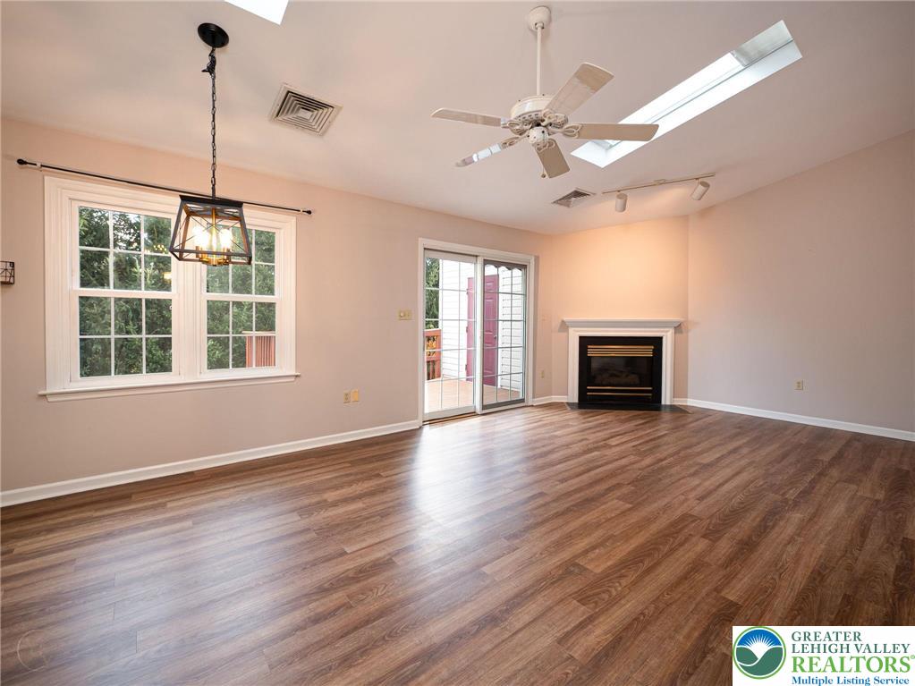 3217 Garfield Avenue, Unit E Reading, PA 19605 - Photo 8 of 45 a view of an empty room with wooden floor fireplace and a window