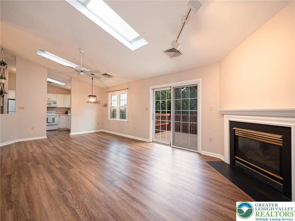 3217 Garfield Avenue, Unit E Reading, PA 19605 - Photo 9 of 45 a view of an empty room with wooden floor fireplace and a window