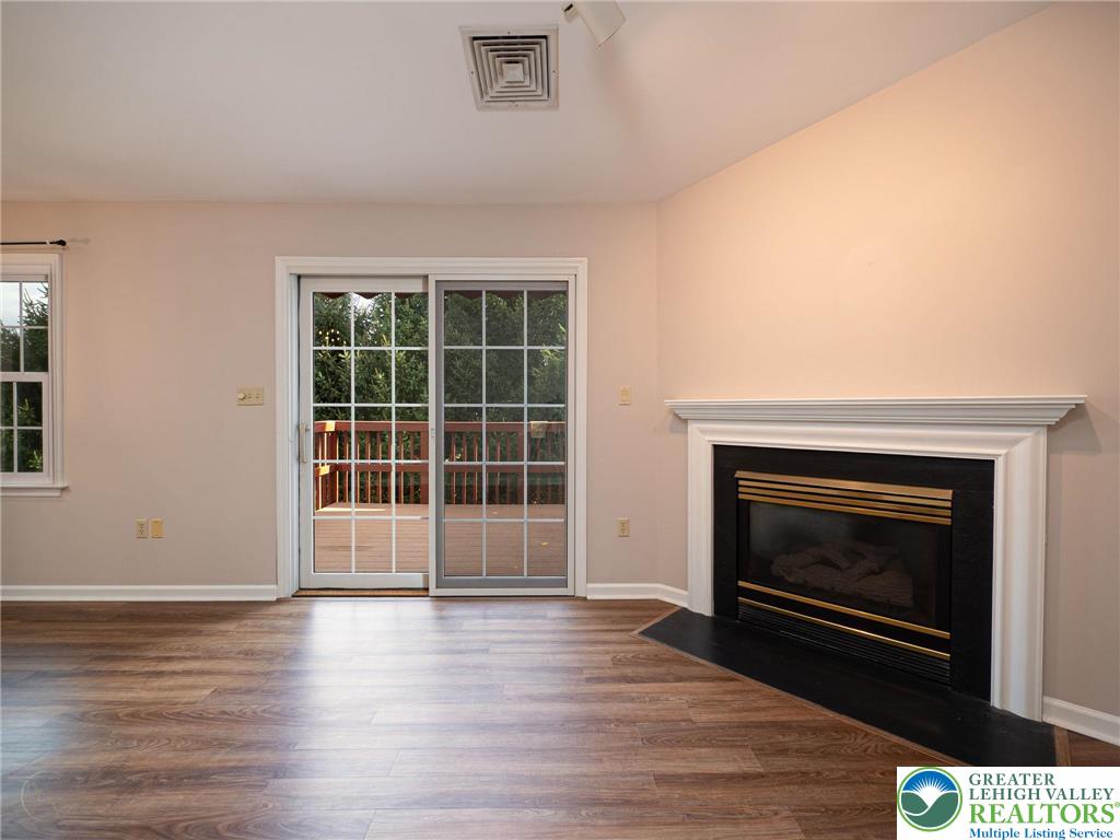 3217 Garfield Avenue, Unit E Reading, PA 19605 - Photo 10 of 45 an empty room with wooden floor and fireplace