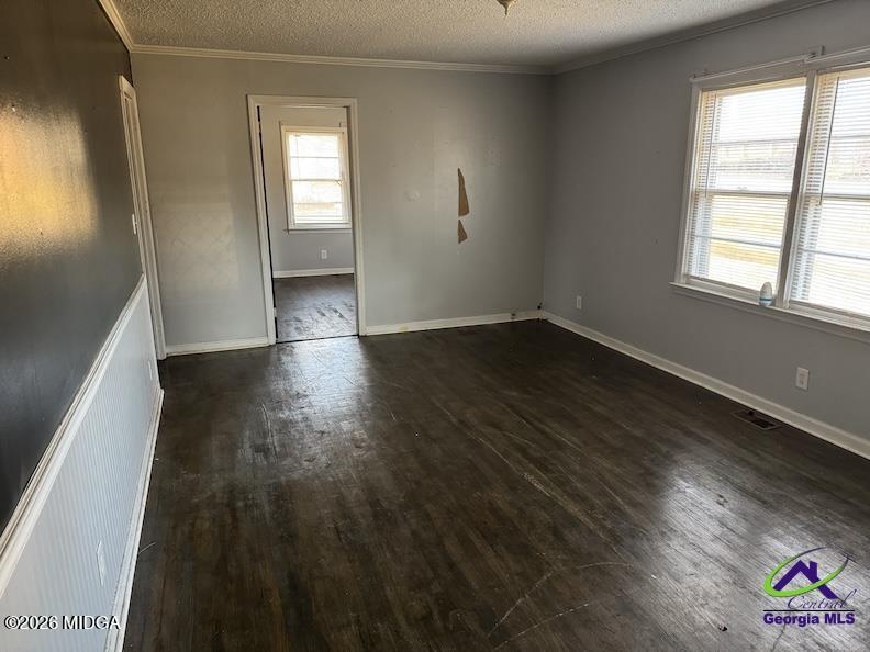151 Edmondson Circle Cochran, GA 31014 - Photo 4 of 16 an empty room with wooden floor and windows