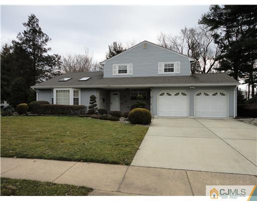 22 Innes Road East Brunswick, NJ 08816 - Photo 1 of 18 a front view of a house with a yard and garage