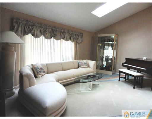 22 Innes Road East Brunswick, NJ 08816 - Photo 2 of 18 a living room with furniture a window and a table